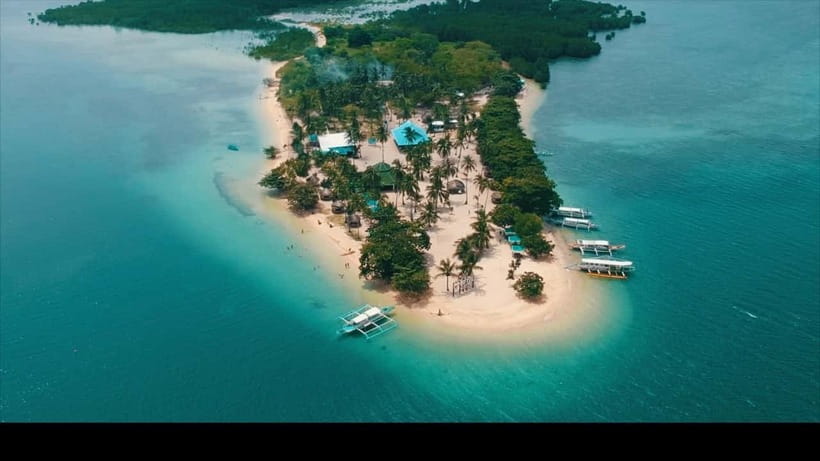 Puerto Princesa: Cowrie Island Guided Day Tour with Meal - Pickup, paperwork, and the boat to Cowrie Island